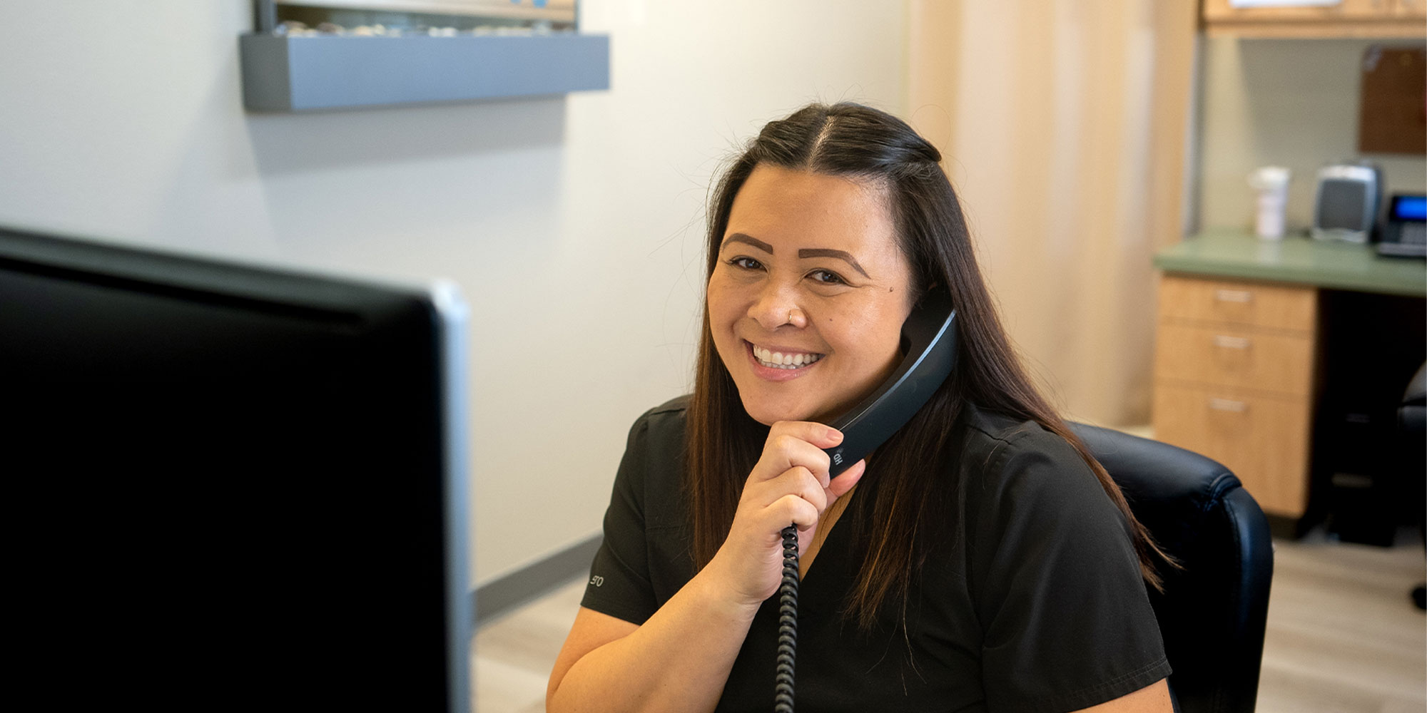 team member talking on the phone with a patient
