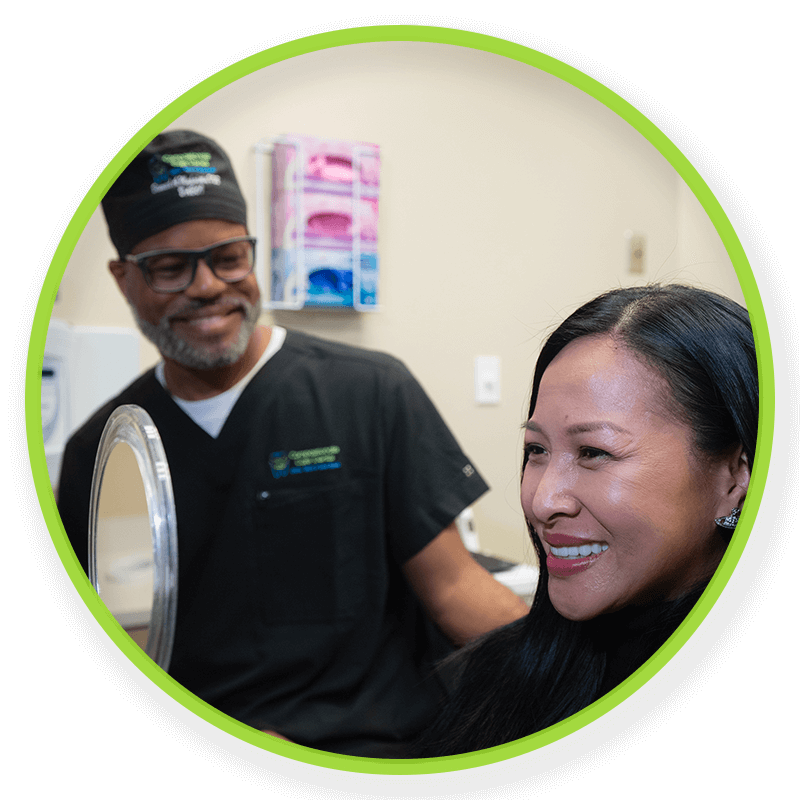 Dr. Dawud Muhaimin. showing patient their new smile