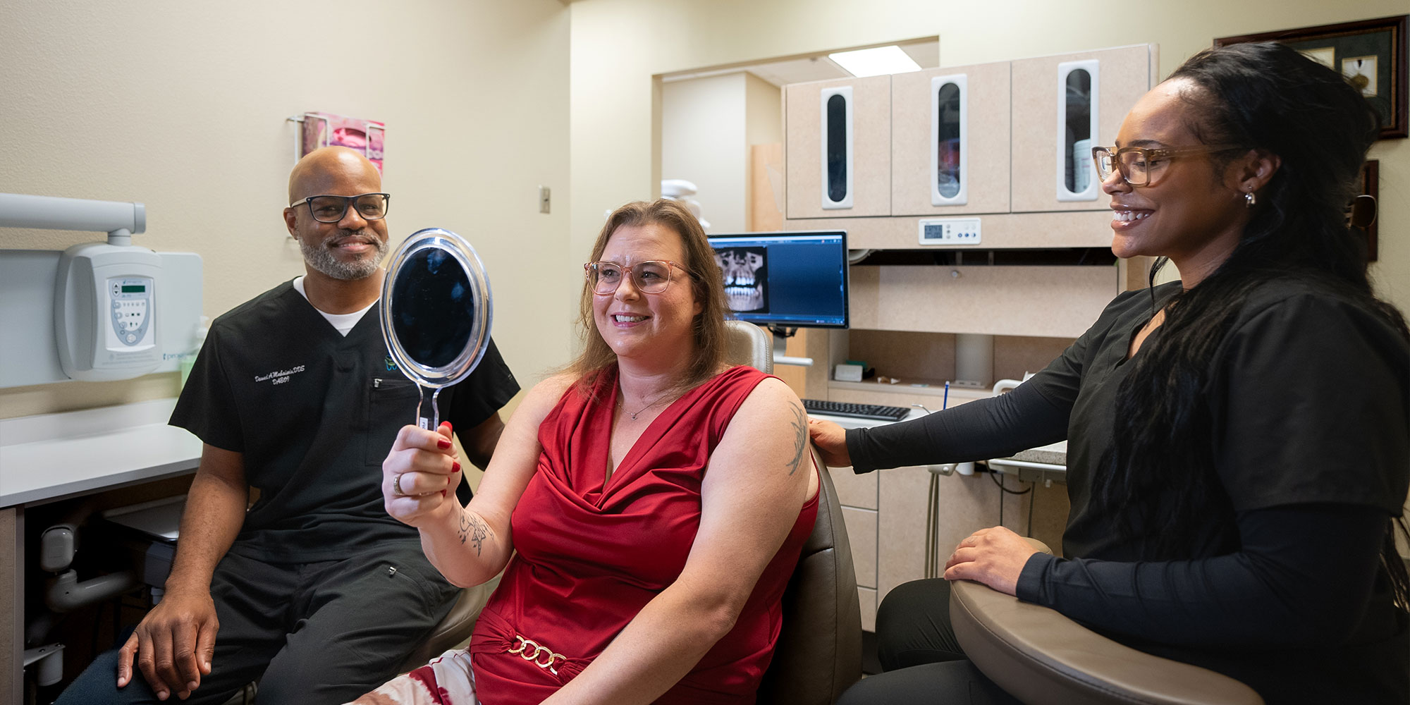 patient looking at their new smile after dental implants