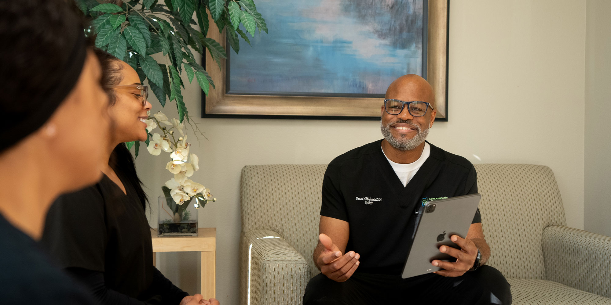 Dr. Dawud Muhaimin going over cost of dental implants