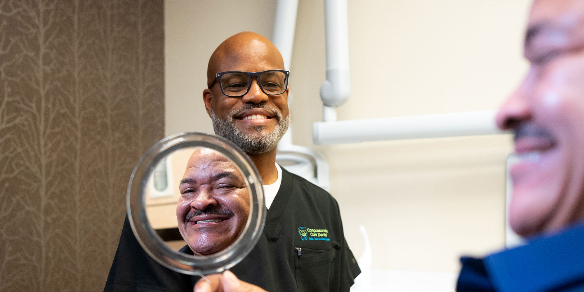 patient looking their new veneers after procedure